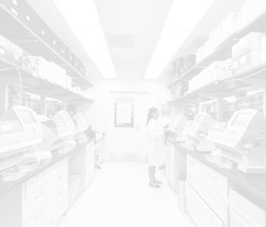 Woman in a lab coat working at a computer in a lab