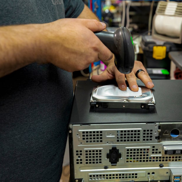 Man scanning a hard drive on top of a computer