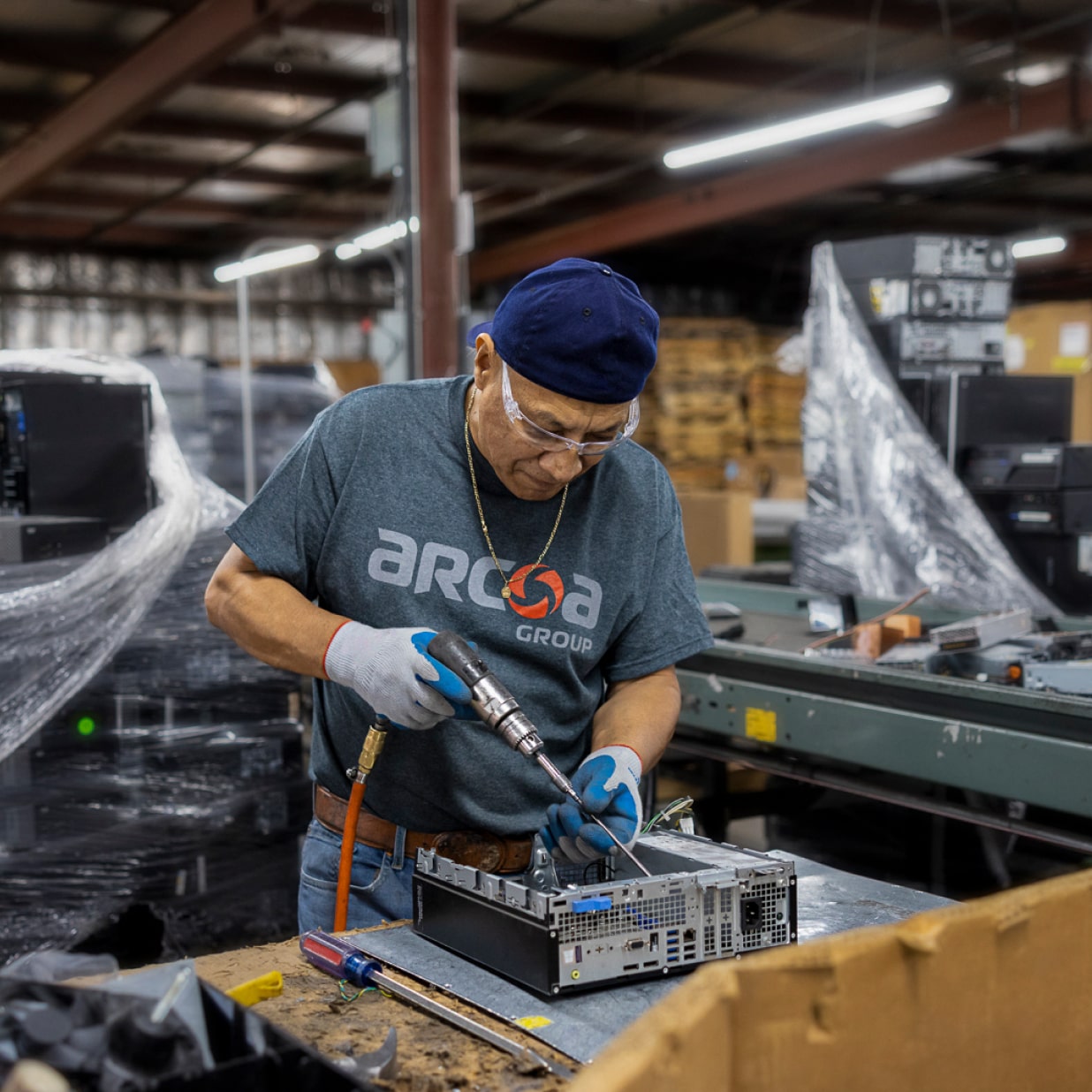 ARCOA employee working on a computer in a warehouse